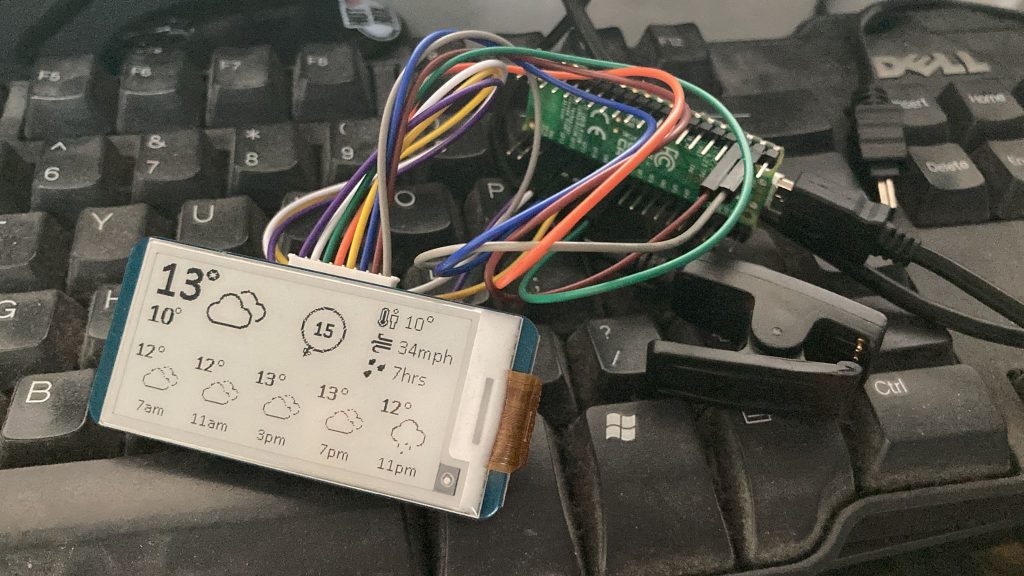 An epaper display showing temperature, weather summary, wind direction and rainfall duration