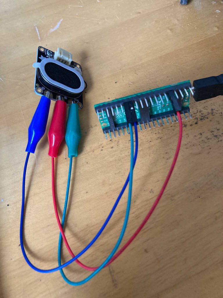 A Raspberry Pico connected to a Adafruit STEMMA Speaker by three crodocile clips